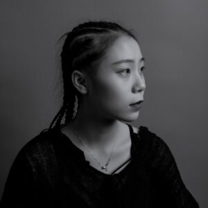 greyscale photography of woman facing at right sied