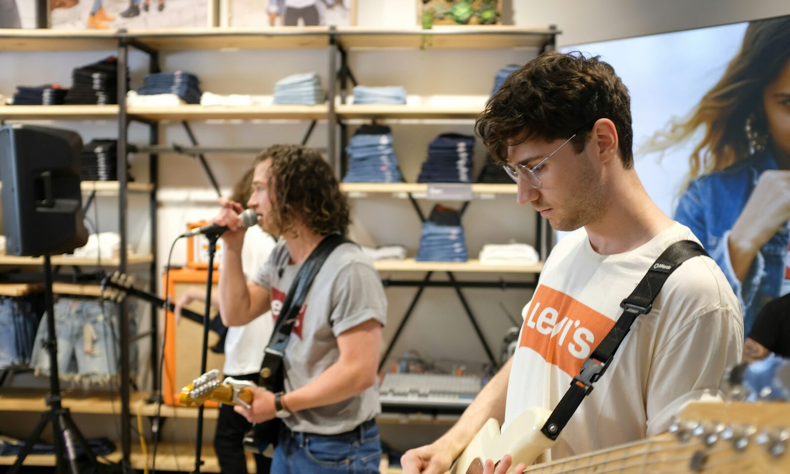 a man playing a bass guitar in a store