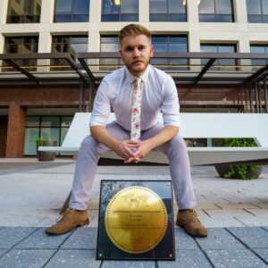 man in white dress shirt sitting on bench