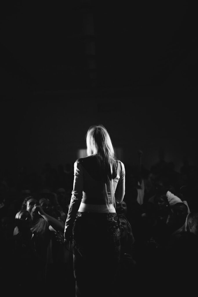 a woman standing in front of a crowd of people