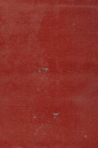 a close up of a red wall with a clock on it