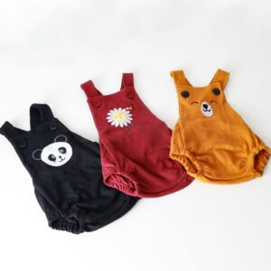 Set of three colorful baby onesies with adorable animal and flower designs on a white background.
